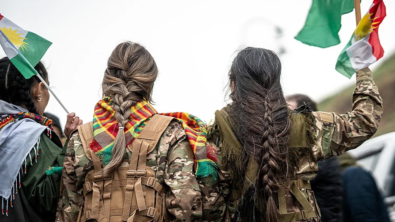 Syrian militiaman shows off what he claims to be severed Kurdish fighter's braid as Damascus asserts control