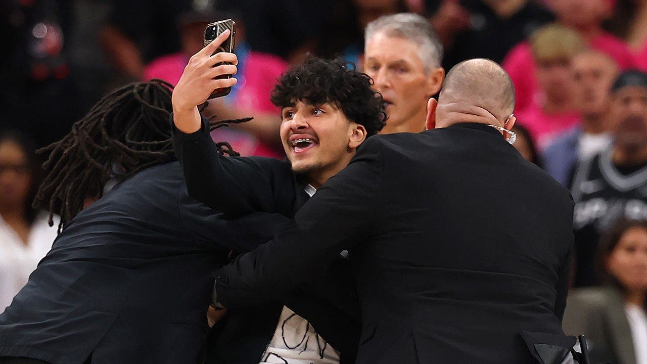 Fan runs onto court attempting selfie with Victor Wembanyama during Game 1 of 2026 NBA Finals; detained and play briefly stopped